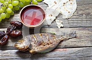 Easter food with fish passover bread cross in goblet of wine last supper abstract photo