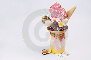 Easter freak shake decorated with Easter bunny gingerbread on li