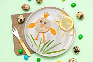 Easter funny creative healthy breakfast lunch food idea for kids, children. chicken shape sandwich from bread, peeled carrots,