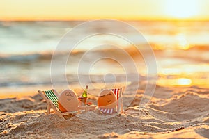 Easter funny eggs relaxing on a beach.