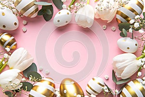 Easter golden eggs and white tulips on pink background