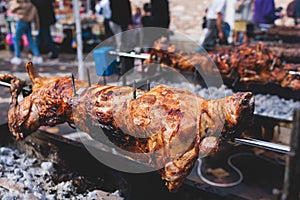 Easter in Greece, process of cooking traditional greek Easter dish - Souvla, grilled lamb, sheep and goat bbq, grilling over