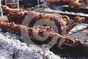 Easter in Greece, process of cooking traditional greek Easter dish - Souvla, grilled lamb, sheep and goat bbq, grilling over