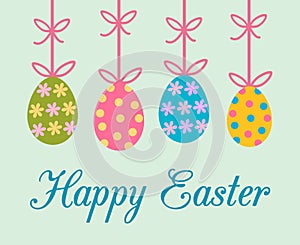 Easter greeting card with colorful decorated painted easter eggs hanging from bow ribbon with stripes, flowers and dots