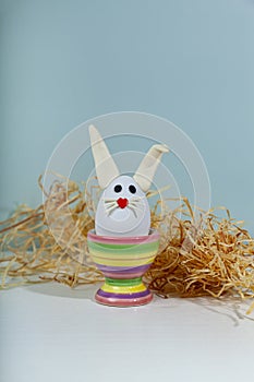 Easter greeting card. Easter egg with bunny ears on a stand