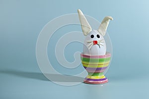 Easter greeting card. Easter egg with bunny ears on a stand