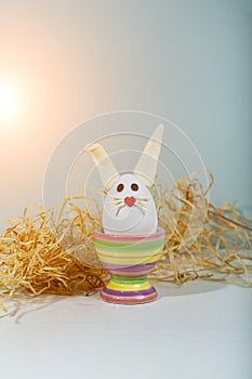 Easter greeting card. Easter egg with bunny ears on a stand