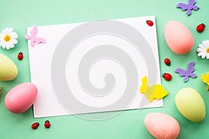 Easter greeting card with eggs and butterflies at color background.