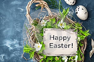 Easter greeting card nestled in basket with eggs and spring flowers