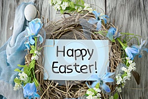 Easter greeting card nestled in basket with eggs and spring flowers