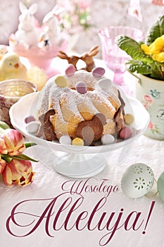 Easter greeting card with traditional ring cake on festive table with inscription in Polish language translated as Happy Easter