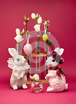 Easter greeting concept. Easter bunny and white spring flowers in vases