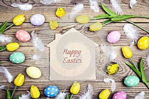 Easter greeting message on the home symbol with eggs, chickens a