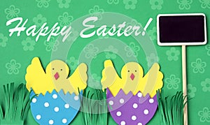 Easter hand made greeting card: hatched chicken in eggshell with blackboard isolated on flower background