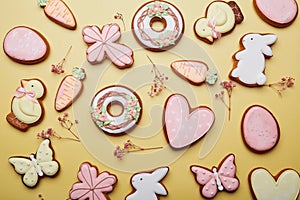 Easter handmade cookies background among gypsophila. Baked pastel symbols of Easter. Spring easter card top view.