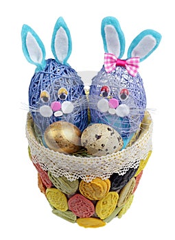 Easter handmade nest from pasta with funny bunnies and quail egg isolated