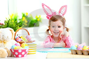 Easter. happy child girl with bunny ears with colored eggs and f