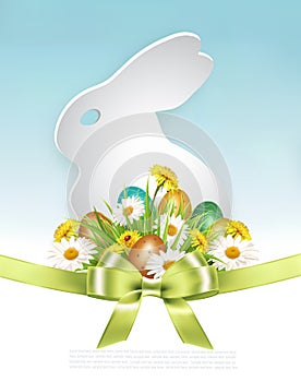 Easter Holiday Background with colofrul eggs in green grass and spring flowers