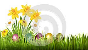 Easter Holiday Background. Colofrul eggs in green grass and spring flowers.