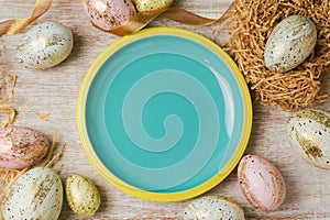 Easter holiday background with empty plate and modern eggs decorations.