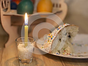 Easter holiday.colorful cakes are on the table .the candle burns
