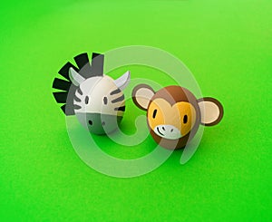 Easter holiday concept with cute handmade eggs: monkey and zebra