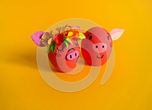 Easter holiday concept with cute handmade eggs: pink pig. Friends piglets