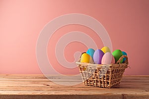 Easter holiday concept with easter eggs in basket on wooden table