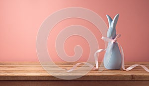 Easter holiday concept with modern bunny on wooden table