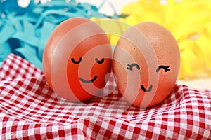 Easter Holiday Concept Two Eggs Smile Happiness on a Red Napkin with Blue Yellow Color Background