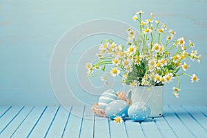 Easter holiday decoration with daisy flowers and painted eggs