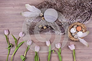 Easter holiday decoration design with eggs feathers fur tulips