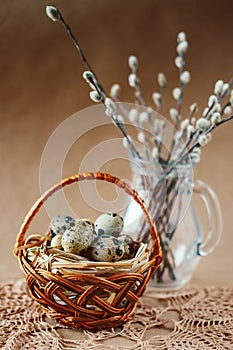 Easter holiday decoration. Quail eggs wrapped in hay in woven b