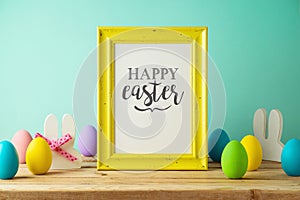 Easter holiday photo frame mock up with Easter eggs  decoration on wooden table