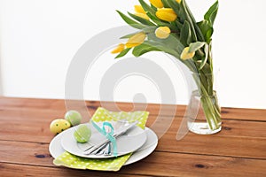 Easter egg in cup holder, plates and cutlery