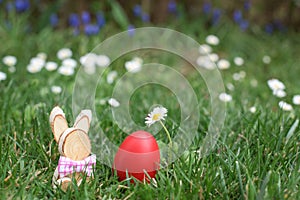 Easter hunt - red egg and wooden bunny