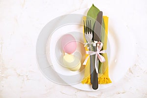 Easter laying table appointments, table setting options. Silverware, tableware items with festive decoration. Fork, knife and flow