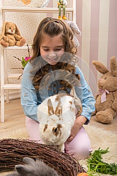 Easter - Little girls stroking the rabbits, the nest