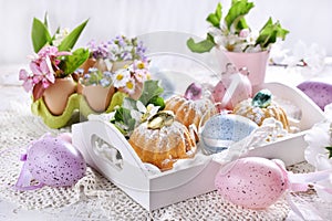 Easter mini ring cakes and floral decoration on festive table