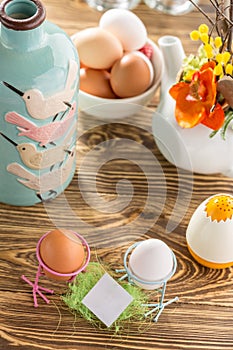 Easter mockup card With Easter Eggs On wooden Background for Seasonal Easter message with blue vase