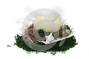 Easter nest with eggs, rabbit and moos on white background