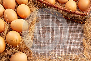 Easter, organic healthy food concept with copy space. Brown eggs on cross section of tree trunk with wicker background.