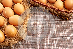 Easter, organic healthy food concept with copy space. Brown eggs on cross section of tree trunk with wicker background.