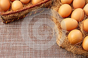 Easter, organic healthy food concept with copy space. Brown eggs on cross section of tree trunk on wicker background.