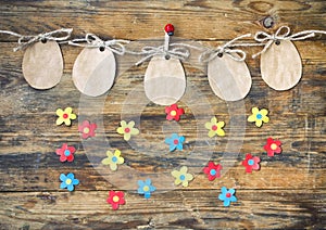 Easter paper tag shape of an egg hanging on rope, applique flowers