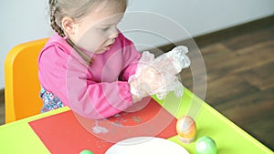 Easter, Passover, childhood, creativity, games concept - closeup of little cute blond three-year-old girl of Slovenian