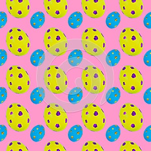 Easter pattern of colored eggs with glitter. Seamless, on a pink background