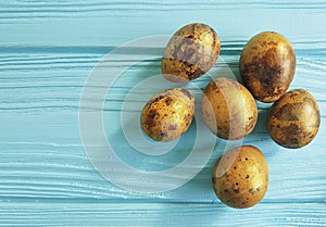 Easter quail eggs on blue wooden