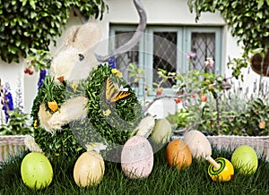 Easter Rabbit & Eggs In Green Grass With Cottage