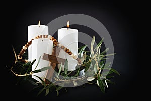 Easter religious dark background with candles cross and olive branches